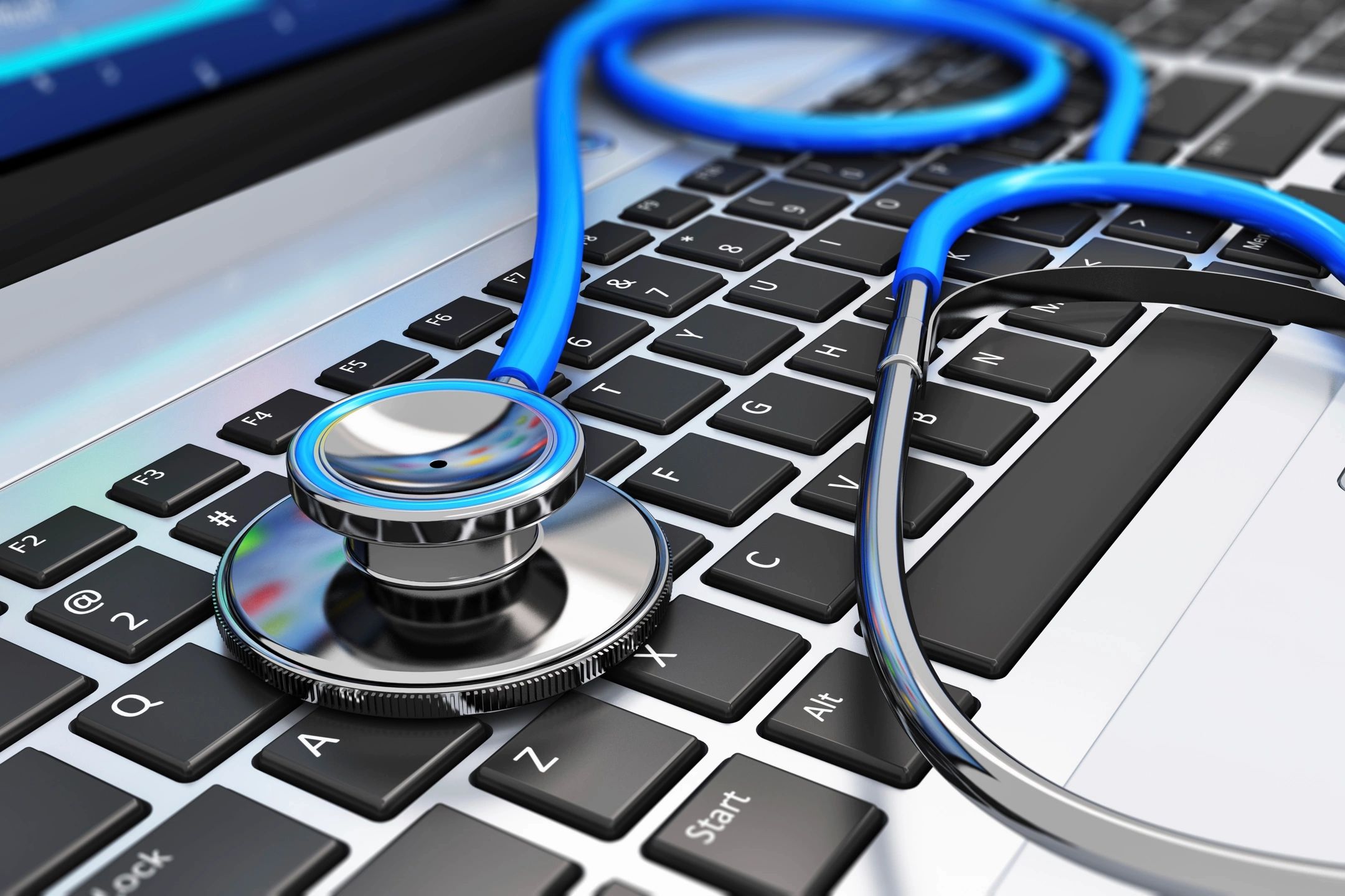 A stethoscope lying on a laptop keyboard