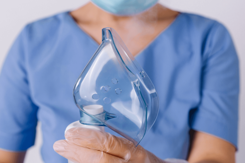 A nurse holding a face mask for a breathing treatment