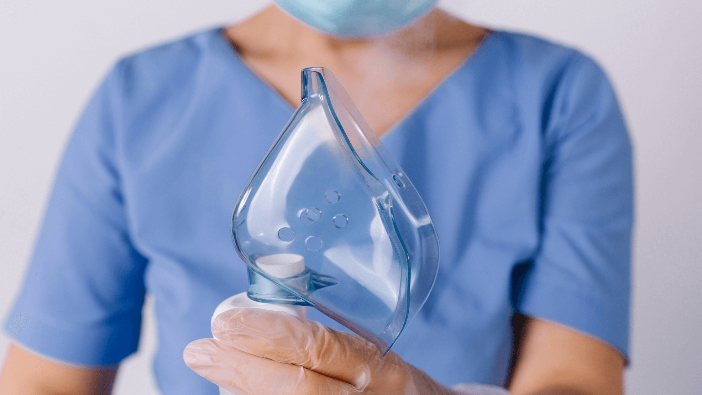 A nurse holding a face mask for a breathing treatment