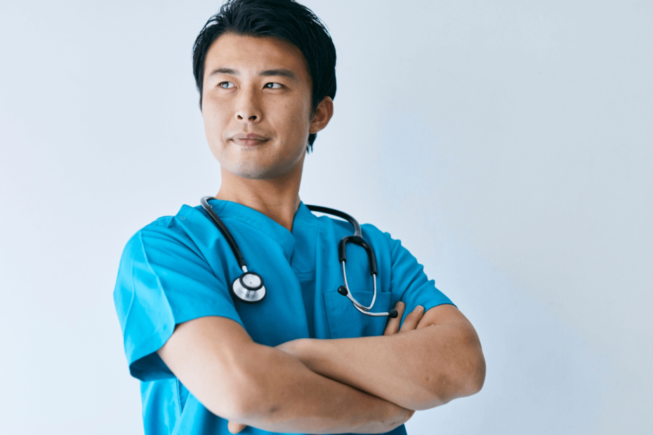 A nurse standing with his arms crossed