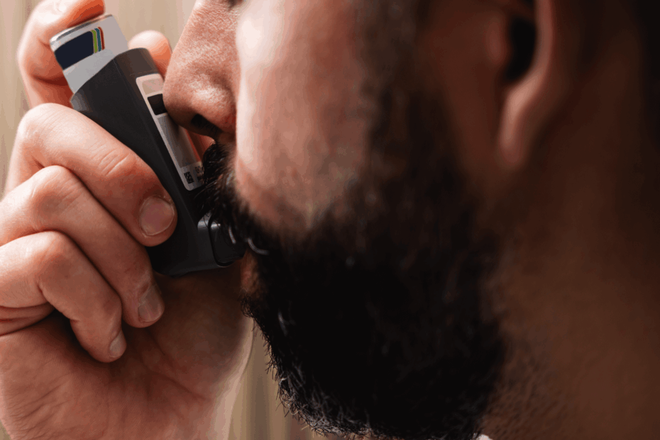 Man taking a puff off an inhaler