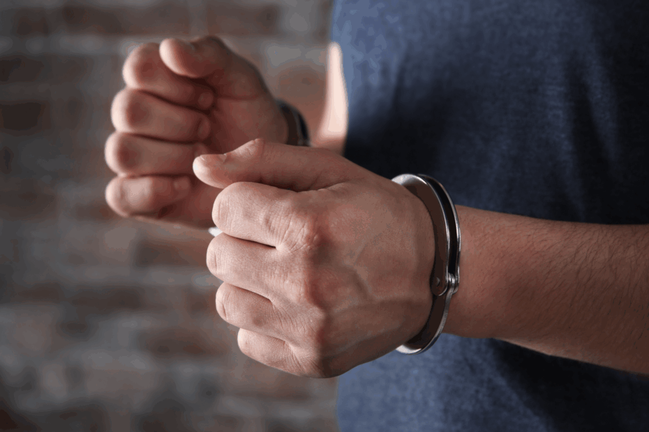 A man's hands in handcuffs