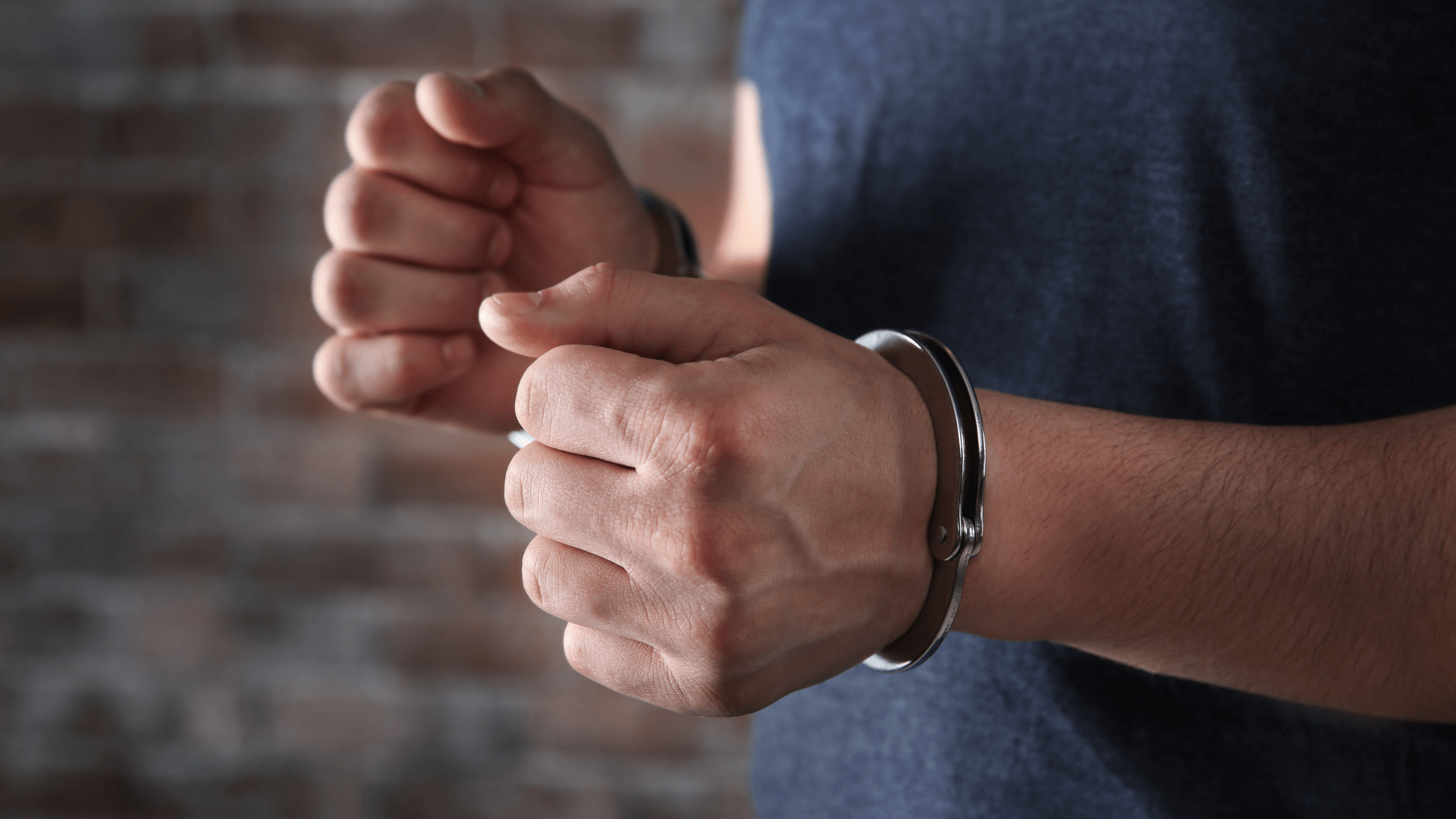 A man's hands in handcuffs