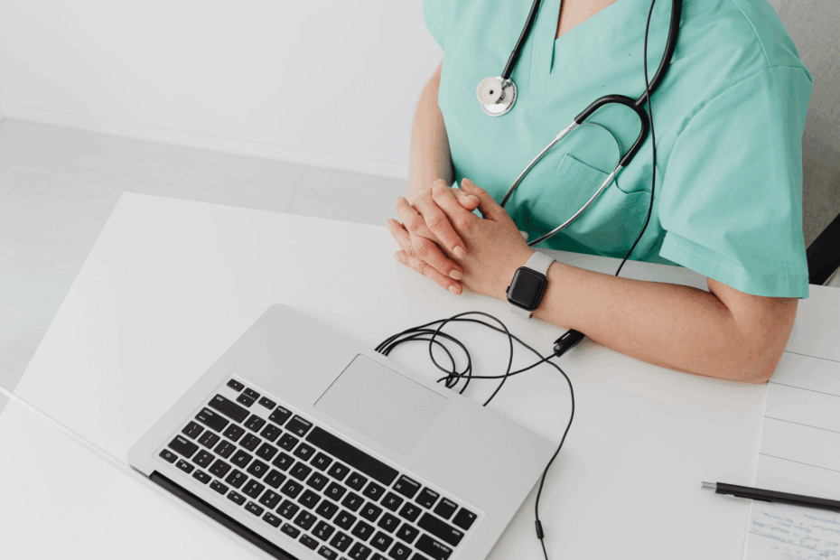 A nurse sitting in front of a laptop