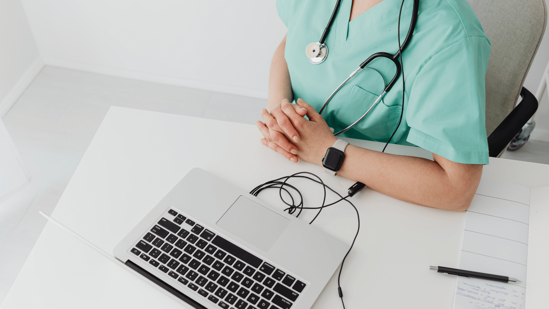 A nurse sitting in front of a laptop