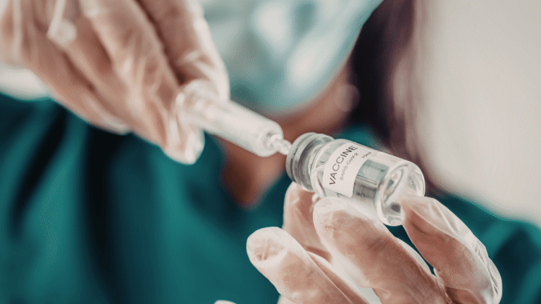 A needle drawing from a vaccine bottle