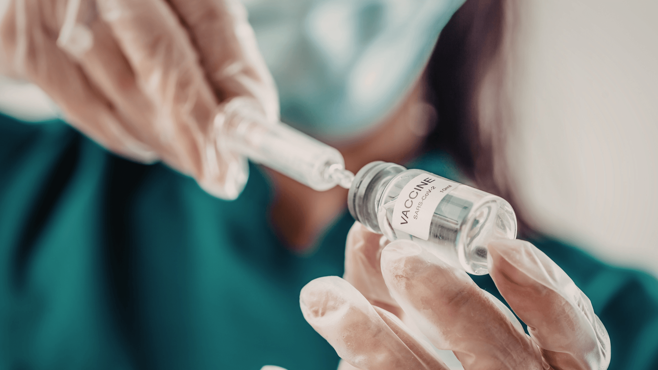 A needle drawing from a vaccine bottle